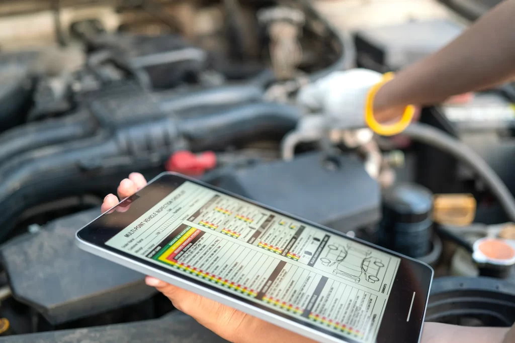 Tech using tablet for vehicle inspection